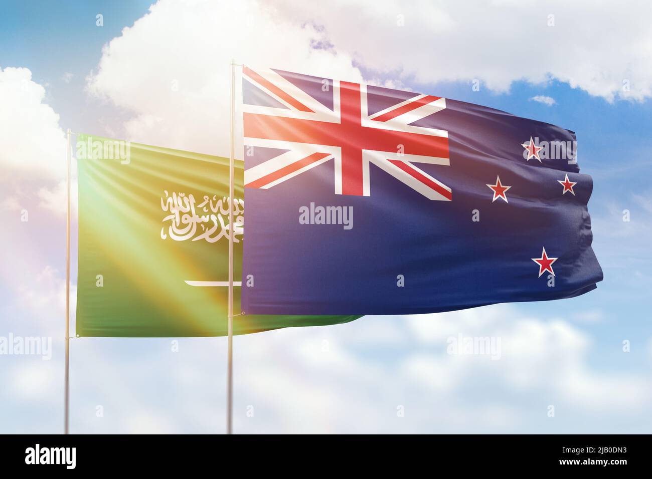 Sunny blue sky and flags of new zealand and saudi arabia Stock Photo
