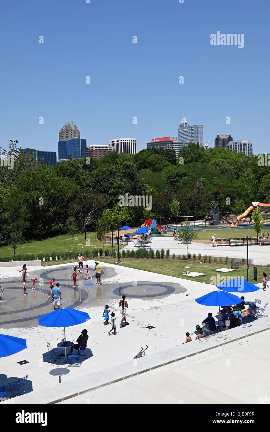 The splash pad at John Chavis Memorial Park with the downtown Raleigh