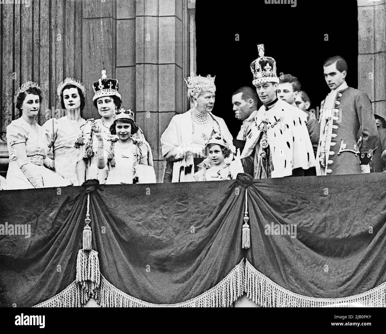 The Queen Elizabeth (2nd-L, future Queen Mother), her daughter Princess Elizabeth (4th-L, future Queen Elizabeth II), Queen Mary (C) , Princess Margaret (5th-L) and the King George VI (R), pose at the balcony of the Buckingham Palace on May 12, 1937 Stock Photo