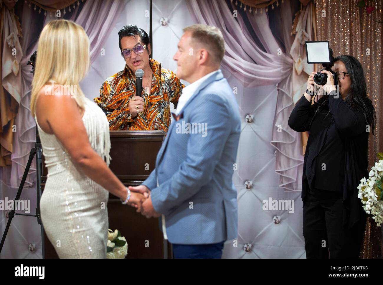 Juliet and Stuart Williams, of Nottingham, England, renew their vows after 10 years of marriage as Elvis Presley tribute artist Jesse Garon officiates and Kim Taylor takes photos at Little Chapel of Hearts in Las Vegas, Nevada, U.S. June 1, 2022.  REUTERS/Steve Marcus Stock Photo