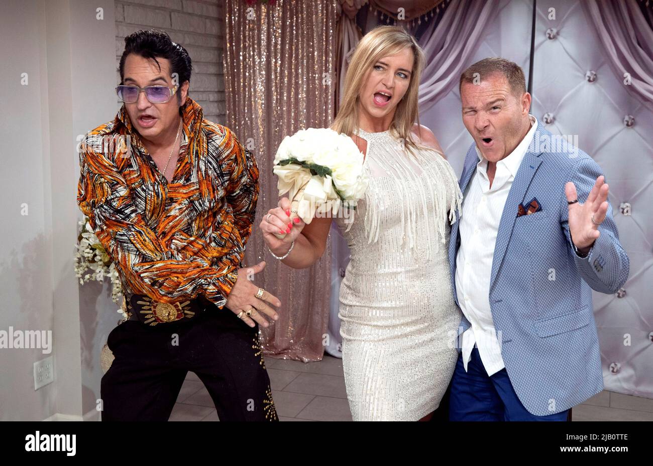 Elvis Presley tribute artist Jesse Garon poses with Juliet and Stuart Williams, of Nottingham, England, during their 10-year marriage vow renewal ceremony at Little Chapel of Hearts in Las Vegas, Nevada, U.S. June 1, 2022.  REUTERS/Steve Marcus Stock Photo