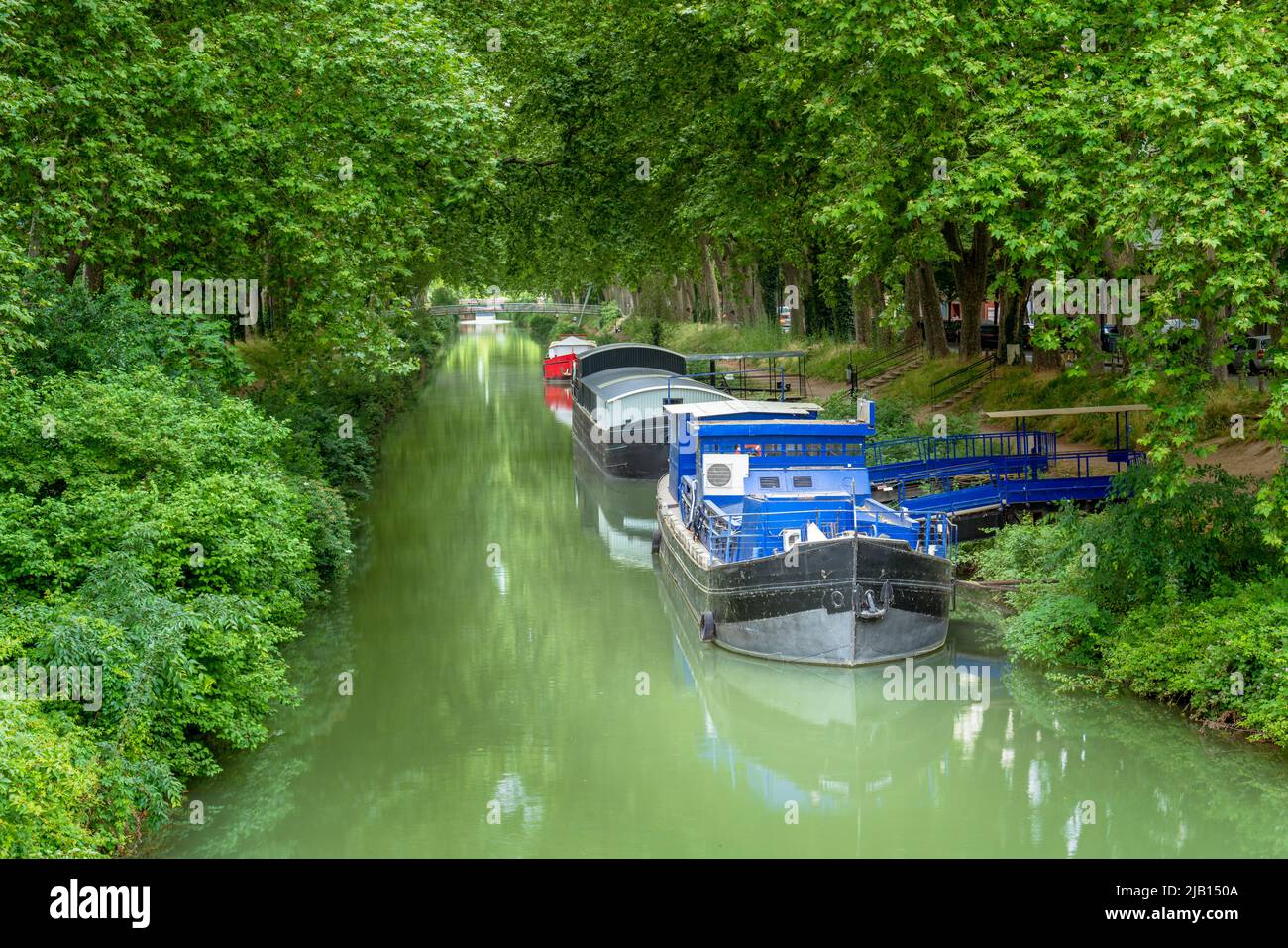 Scenic view of Canal de Brienne with barges moored, Toulouse France Stock Photo