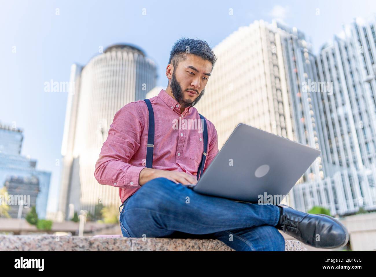 Portrait of a chinese man working with a laptop Stock Photo