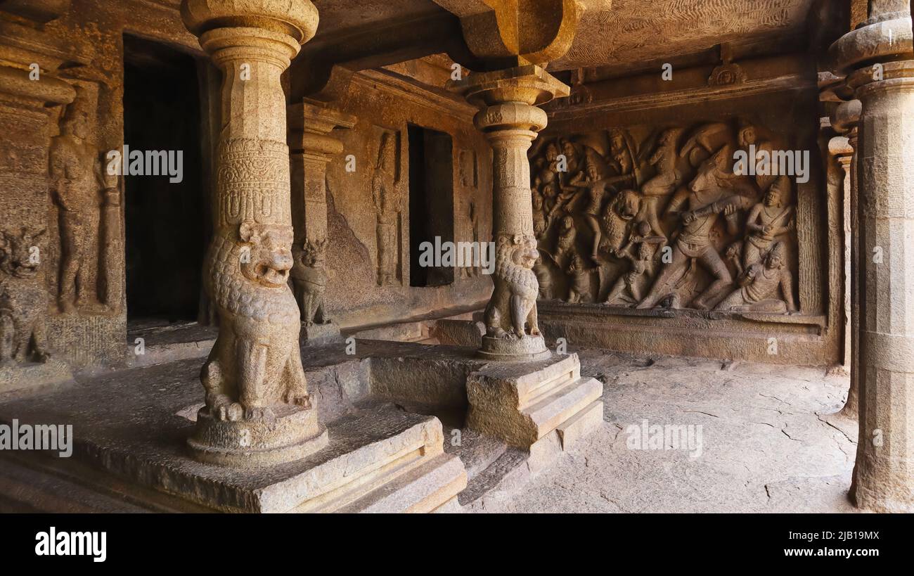 Mahishasuramardini cave interior, Lion pillars and panel of Durga attacking the buffalo demon on right, Mahabalipuram, Tamil Nadu, India Stock Photo