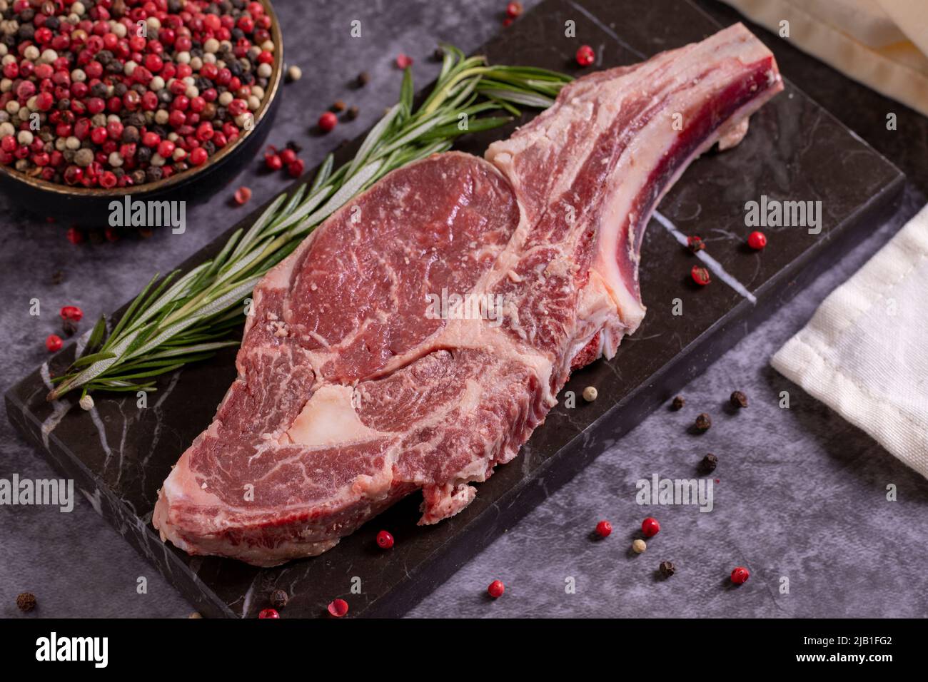 Veal chops on dark background. Fresh raw veal chops with spices. close