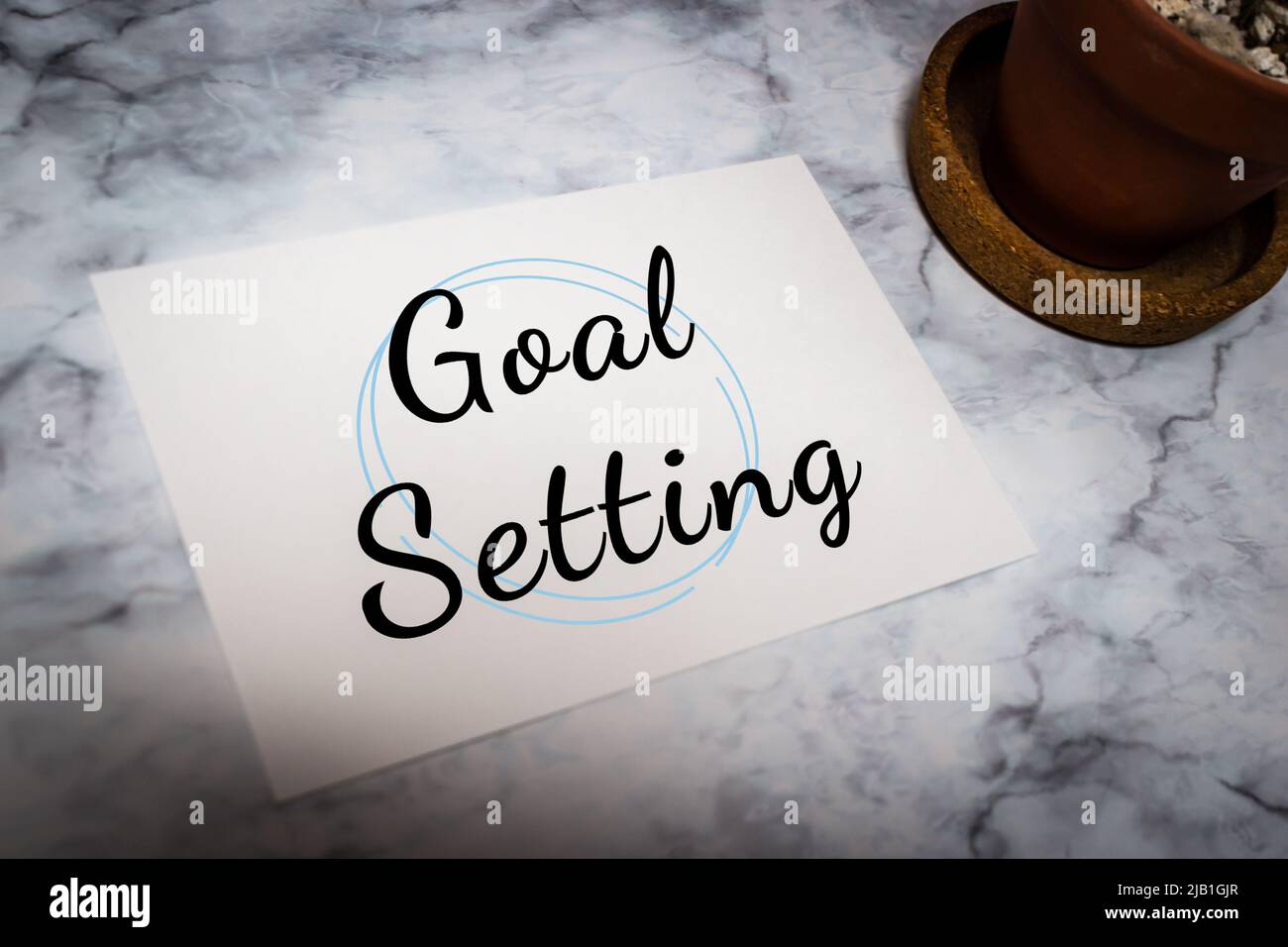 Handwriting Message card “Goal Setting: on white marble table with cactus. Action of setting personal goals, task, business & work commitment concept Stock Photo
