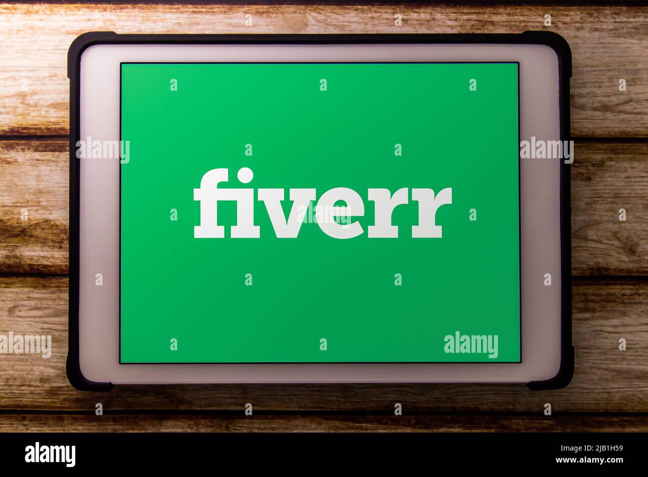 Kumamoto, JAPAN - Jun 16 2021 : Closeup logo of Fiverr on tablet on faded shabby table. Fiverr is an Israeli online marketplace for freelance services Stock Photo