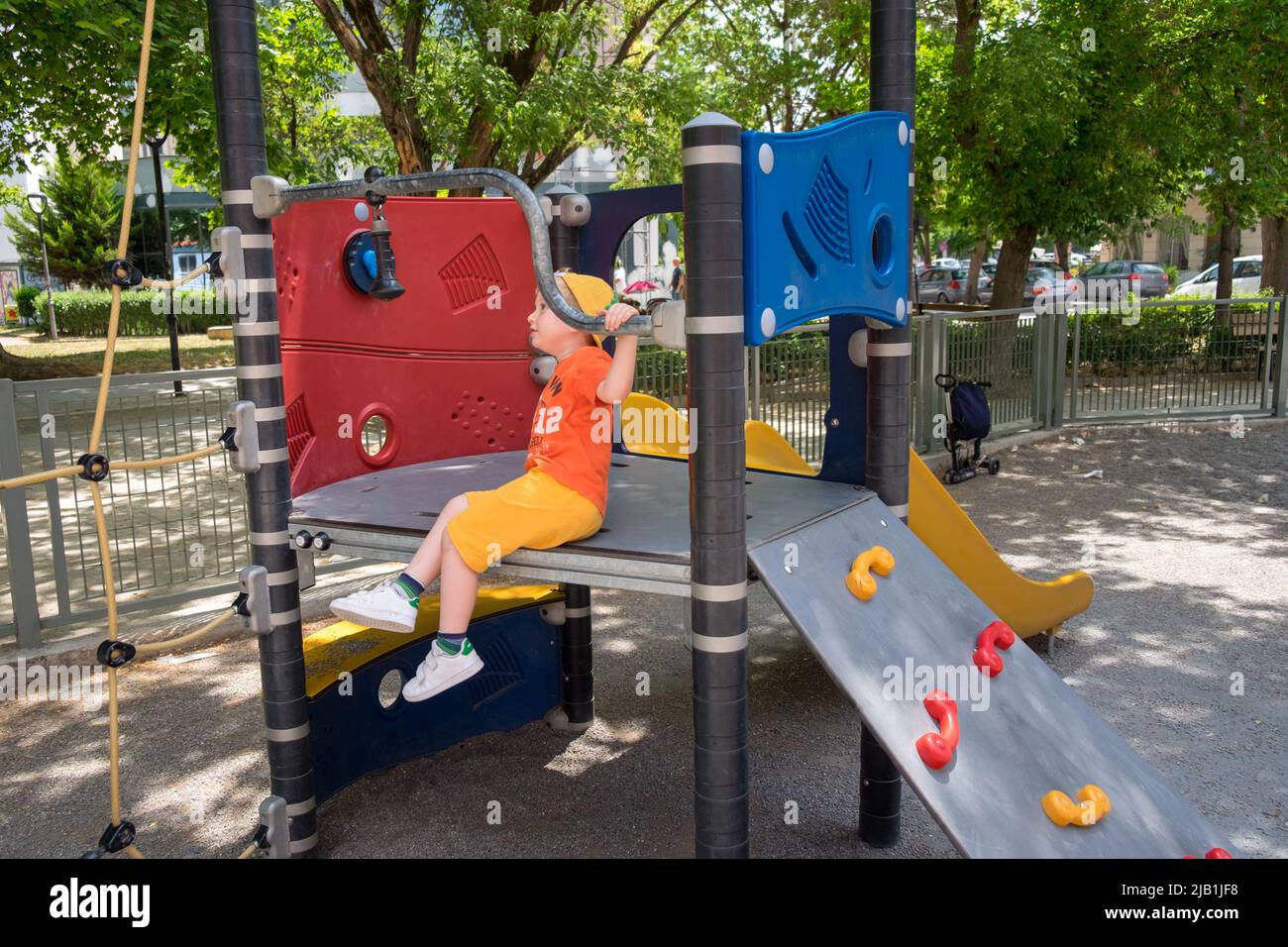 Cute little boy playing in the playground Stock Photo - Alamy