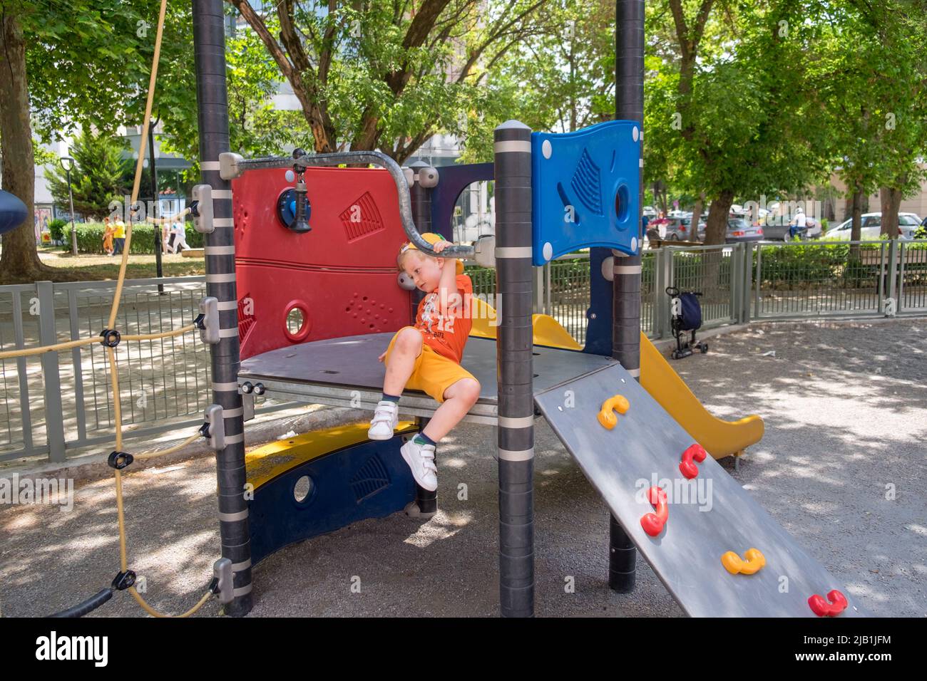 Cute little boy playing in the playground Stock Photo - Alamy