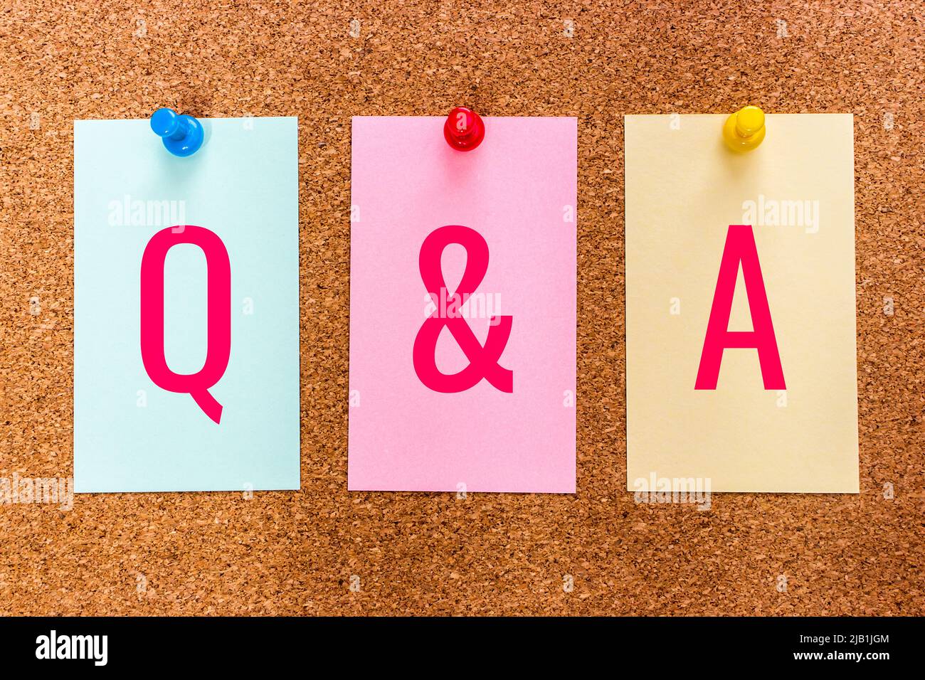 Conceptual 3 letter keyword Q AND A (Question And Answer) on multicolored stickers attached to a cork board. Stock Photo