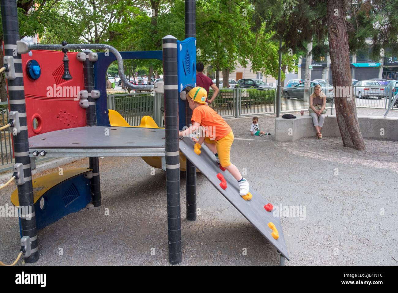 Cute little boy playing in the playground Stock Photo - Alamy