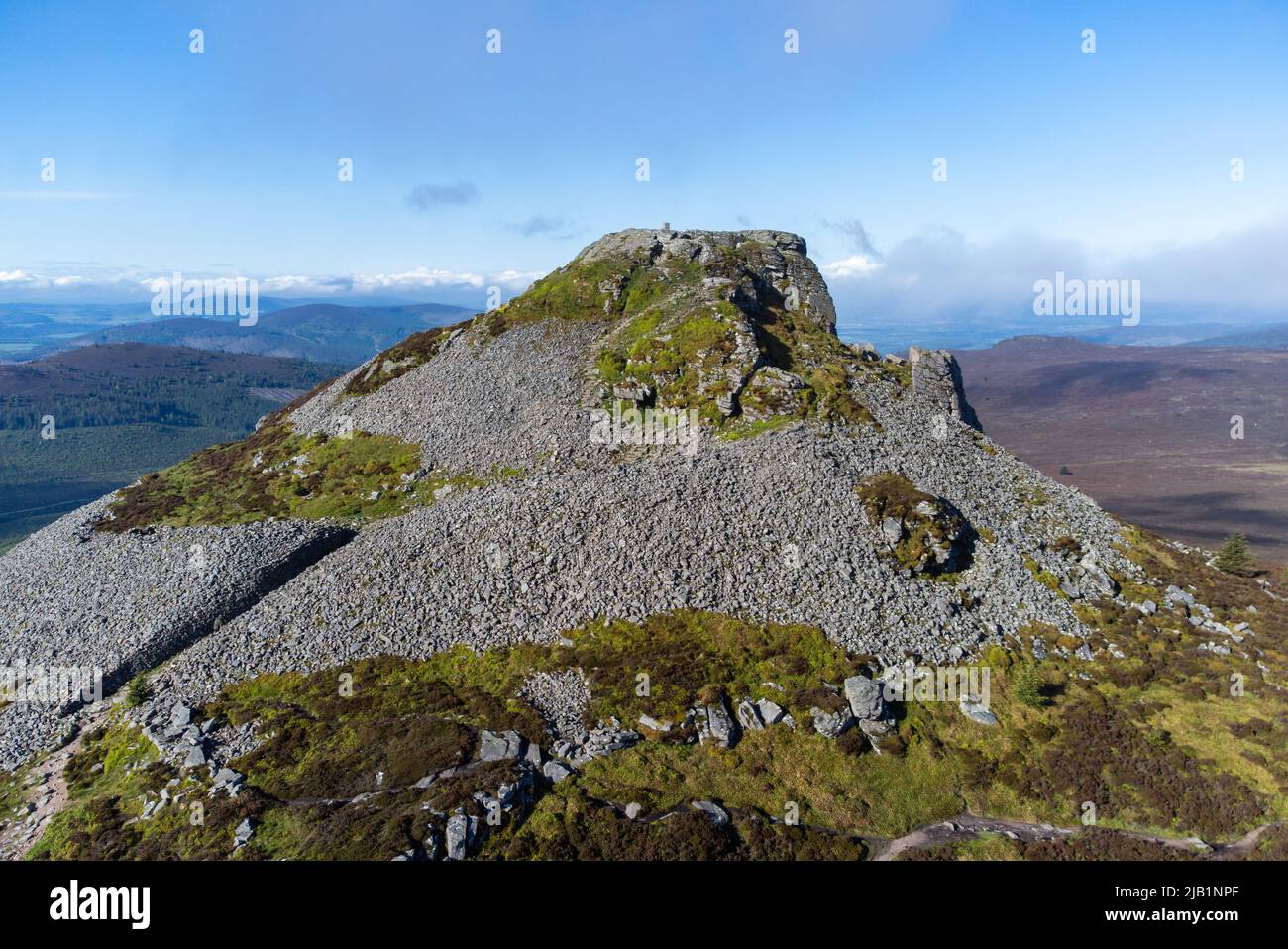 Aerial photograph of the distinctive granite plug and hillfort remains on the Mither Tap on top of the mountain of Bennachie, Aberdeenshire, Scotland Stock Photo