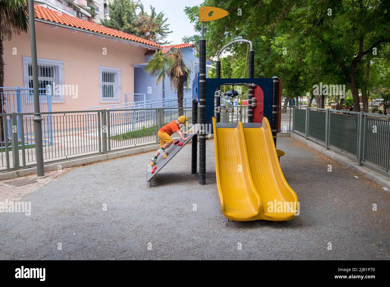 Cute little boy playing in the playground Stock Photo - Alamy
