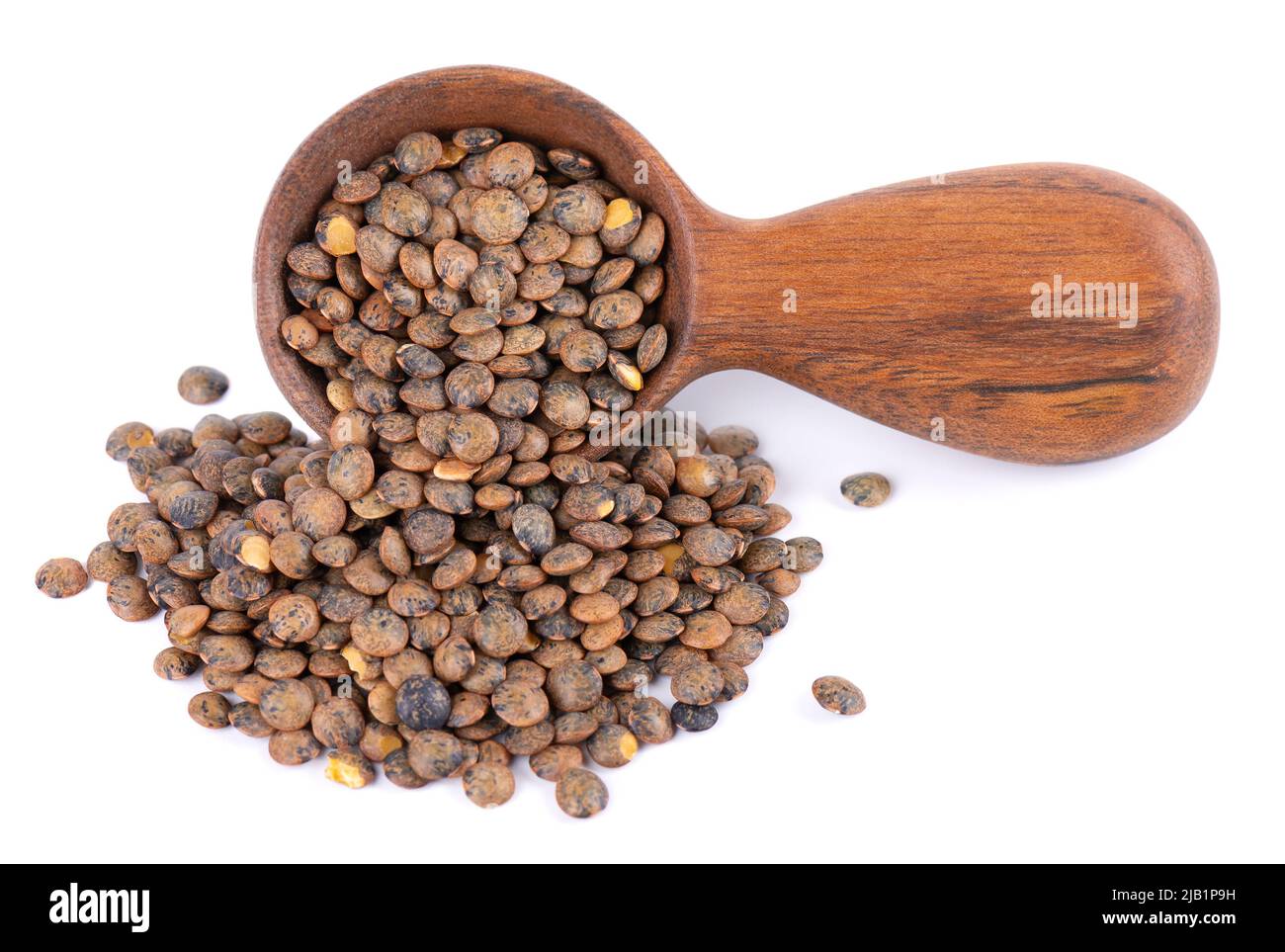 French lentils in wooden spoon, isolated on white background. Dry puy lentil grains pile Stock Photo
