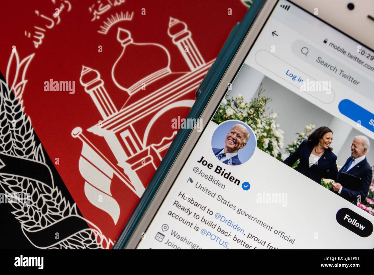 Kumamoto, JAPAN - Aug 26 2021 : Conceptual image 46th US president Joe Biden twitter account on iPhone on Afghanistan flag. Stock Photo