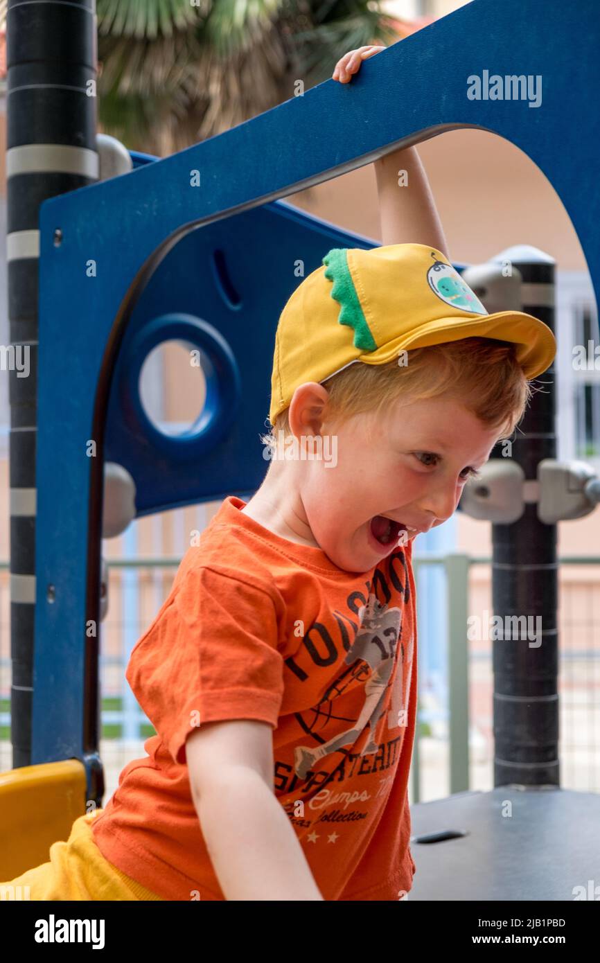 Cute little boy playing in the playground Stock Photo - Alamy