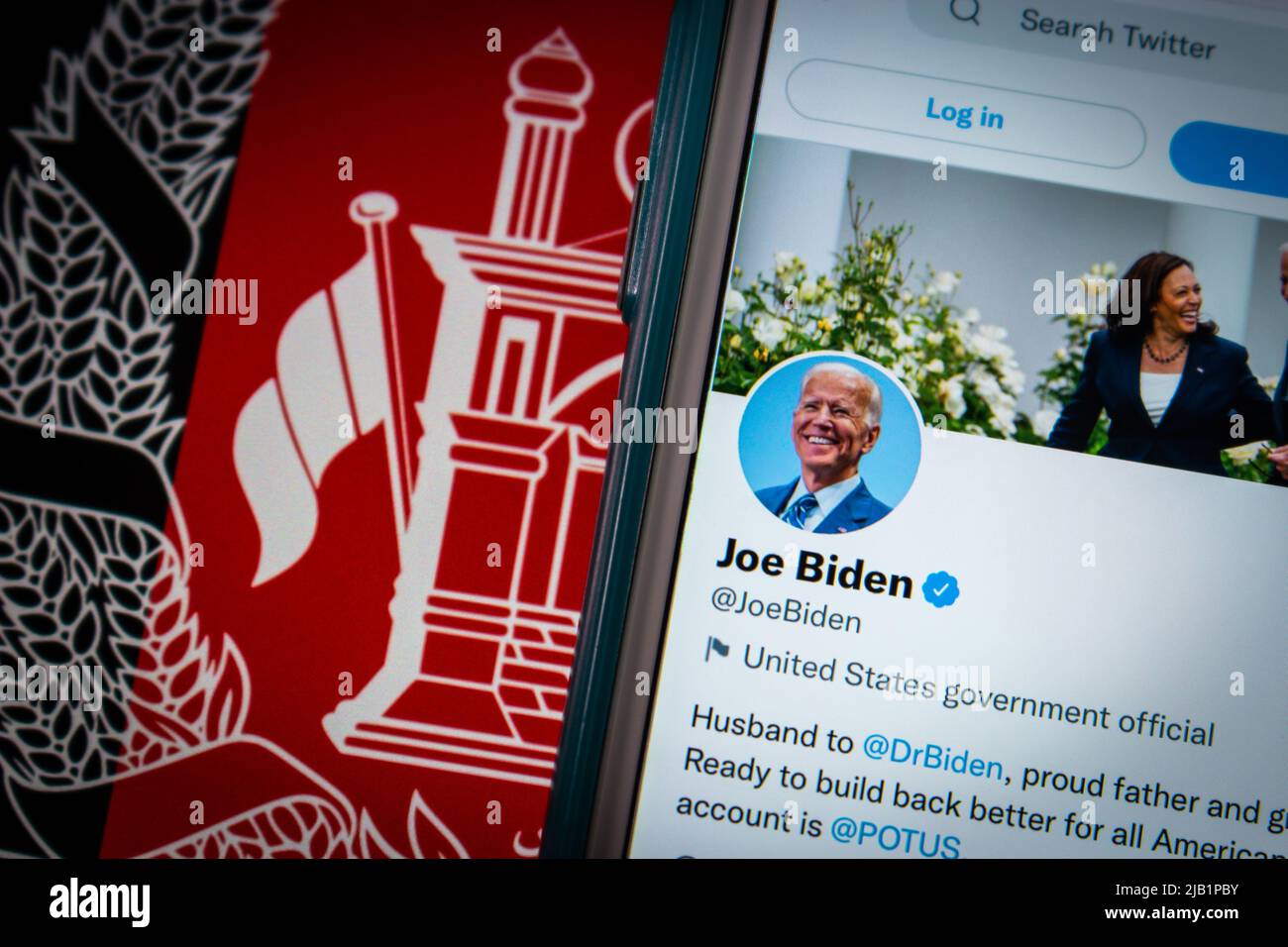 Kumamoto, JAPAN - Aug 26 2021 : Conceptual image 46th US president Joe Biden twitter account on iPhone on Afghanistan flag in dark mood. Stock Photo