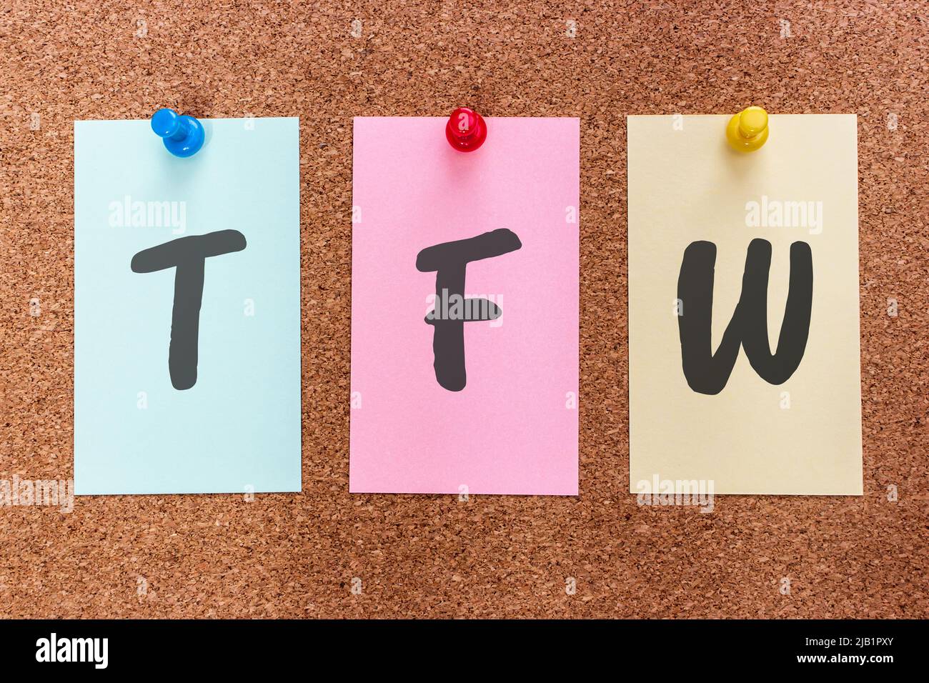 Conceptual 3 letter acronym abbreviation TFW (That feeling when) on multicolored stickers attached to a cork board. Stock Photo