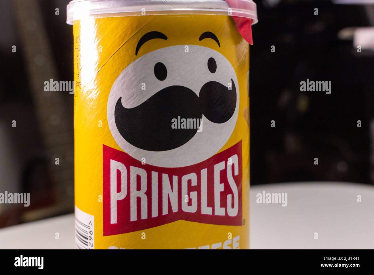 Kumamoto, JAPAN - Sep 3 2021 : Closeup a package of Pringles, an US brand of stackable potato-based crisps (potato chips), on a table. Stock Photo