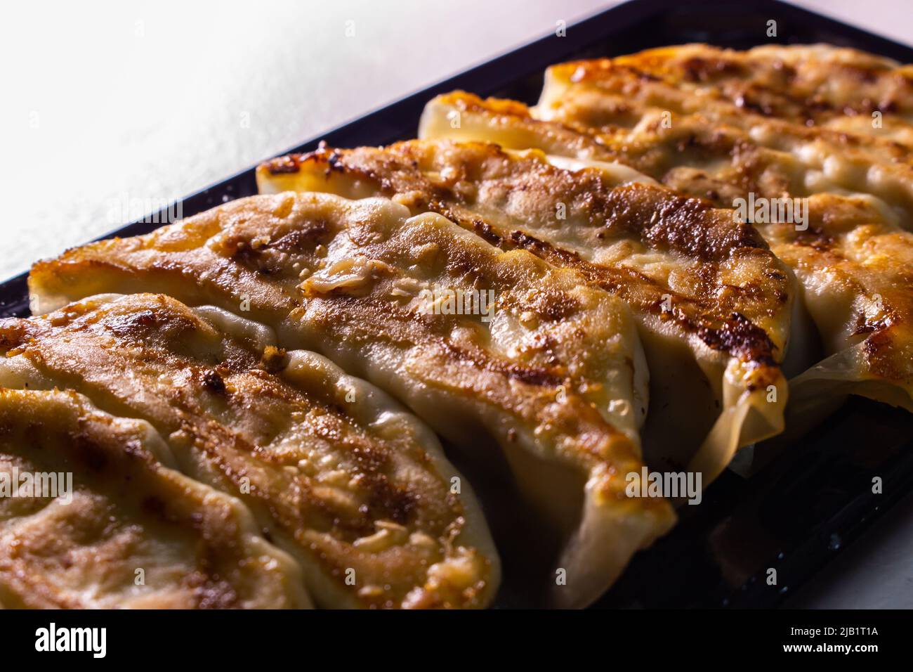 Closeup Japanese-style Jiaozi, Gyoza, sold by Japanese supermarket. Chinese dumplings Jiaozi commonly eaten in China, and other parts of East Asia. Stock Photo