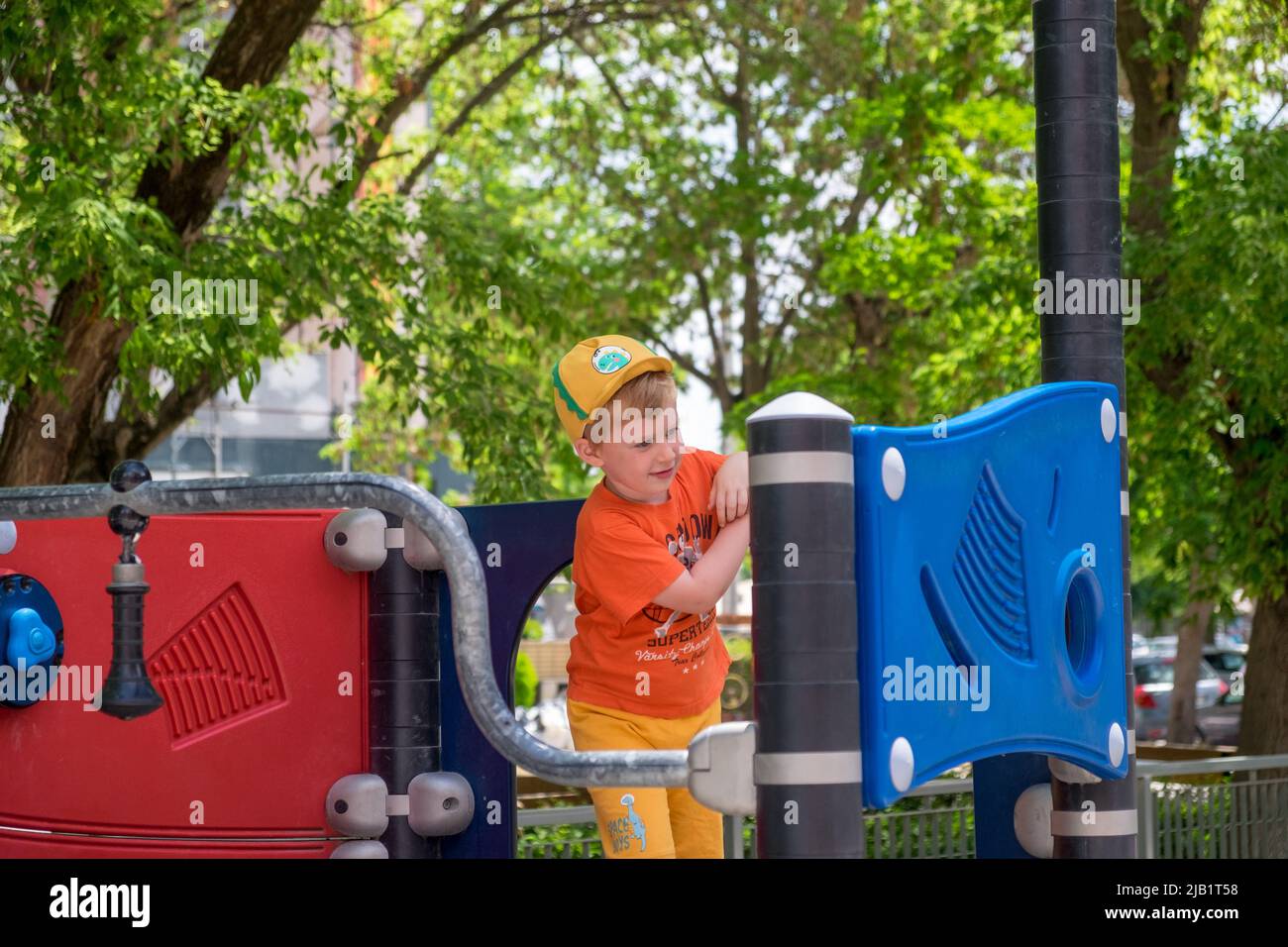 Cute little boy playing in the playground Stock Photo - Alamy