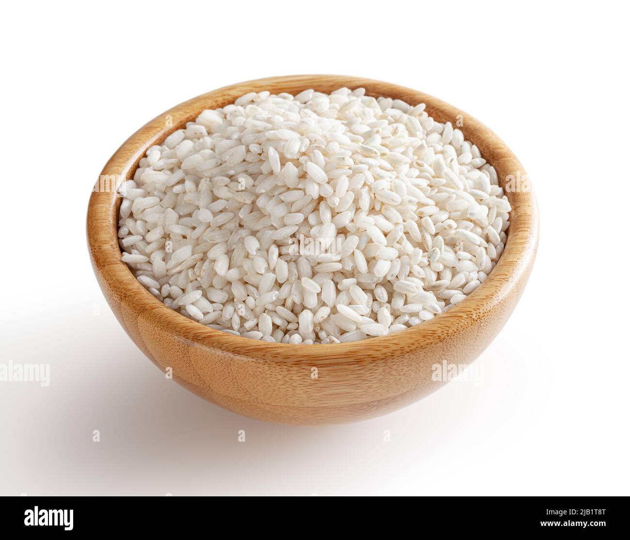 Uncooked arborio rice in wooden bowl isolated on white background with