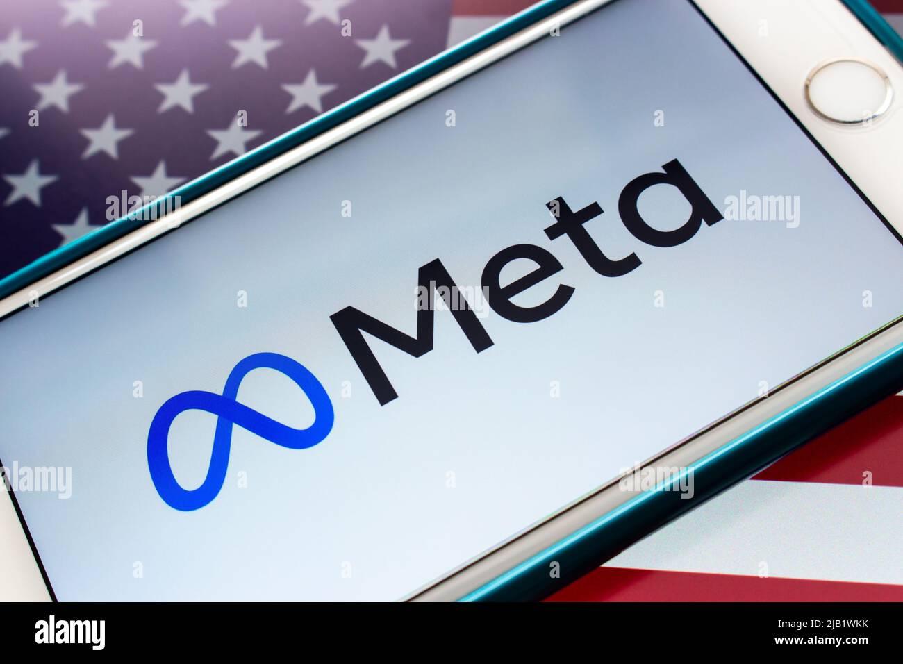 Logo of US technology conglomerate Meta Platforms, Inc. on an iPhone on US flag. In Oct 2021, Facebook Changes Corporate Name to Meta Stock Photo