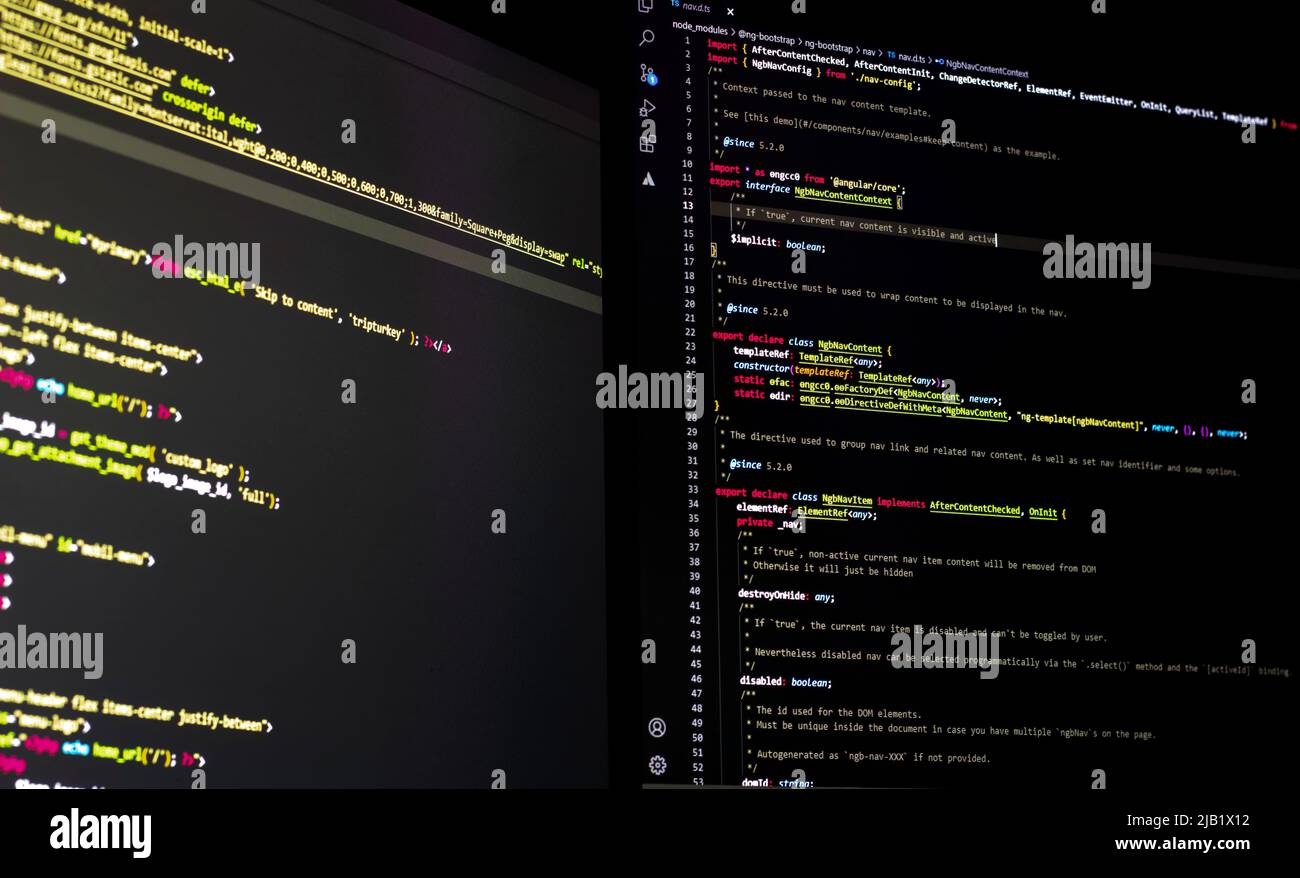 The software developer using dual screen is coding Stock Photo - Alamy