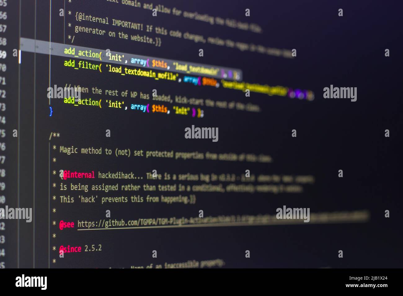 The software developer using dual screen is coding. Stock Photo