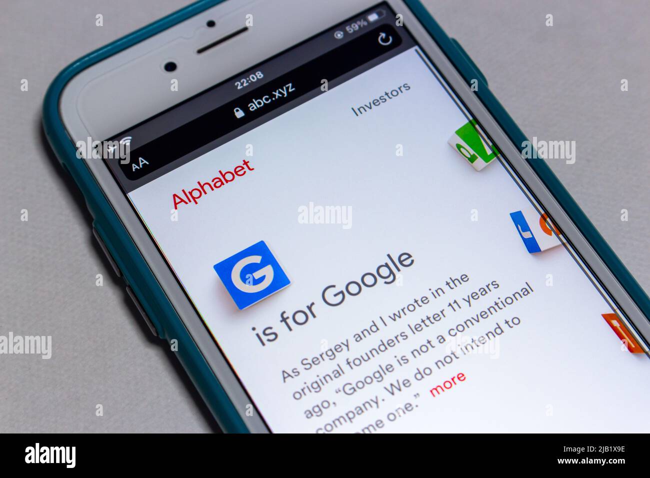 Website of US multinational conglomerate Alphabet inc. on iPhone screen. Alphabet inc. was created through a restructuring of Google on Oct 2, 2015. Stock Photo