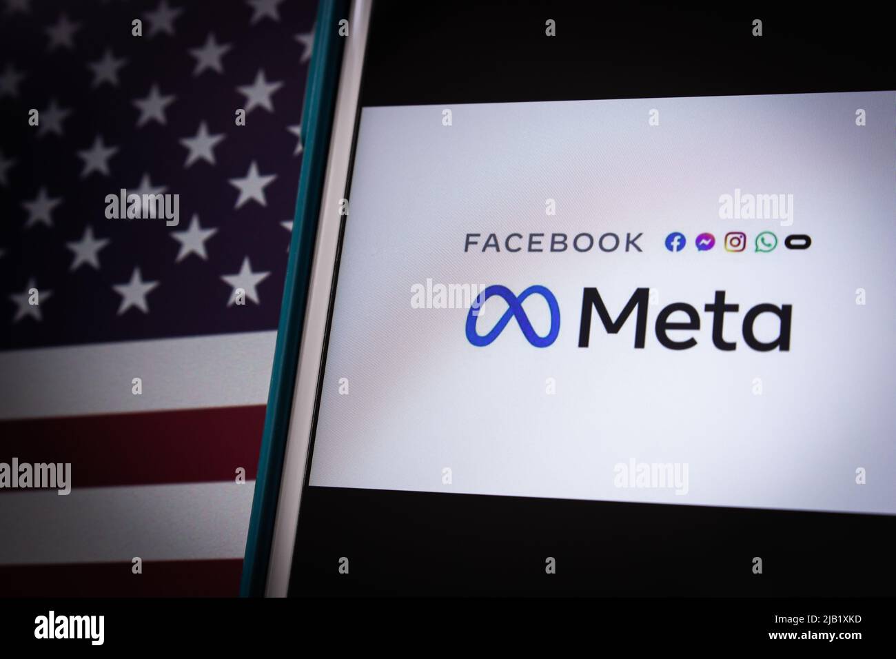 Logo of US technology conglomerate Meta Platforms, Inc. on an iPhone on US flag in dark mood. In Oct 2021, Facebook Changes Corporate Name to Meta Stock Photo