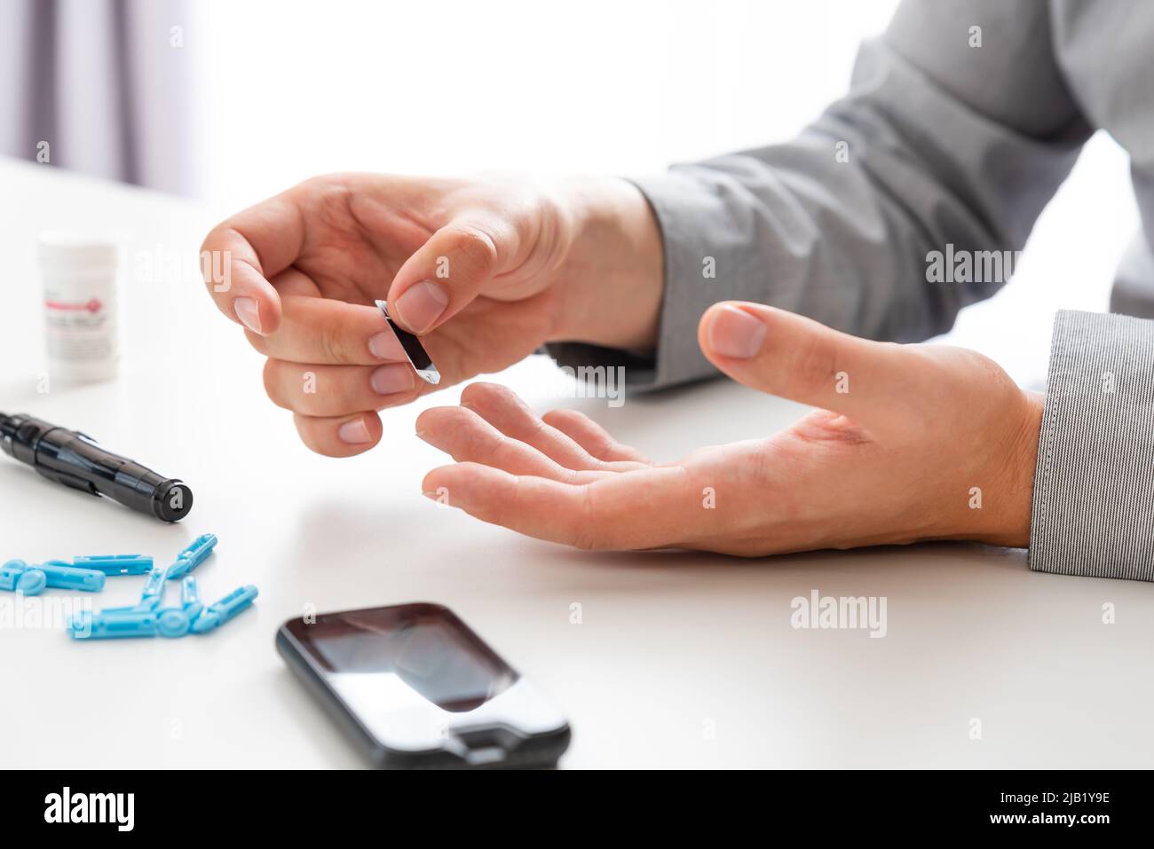 Man using glucometer. Diabetes blood test kit Stock Photo