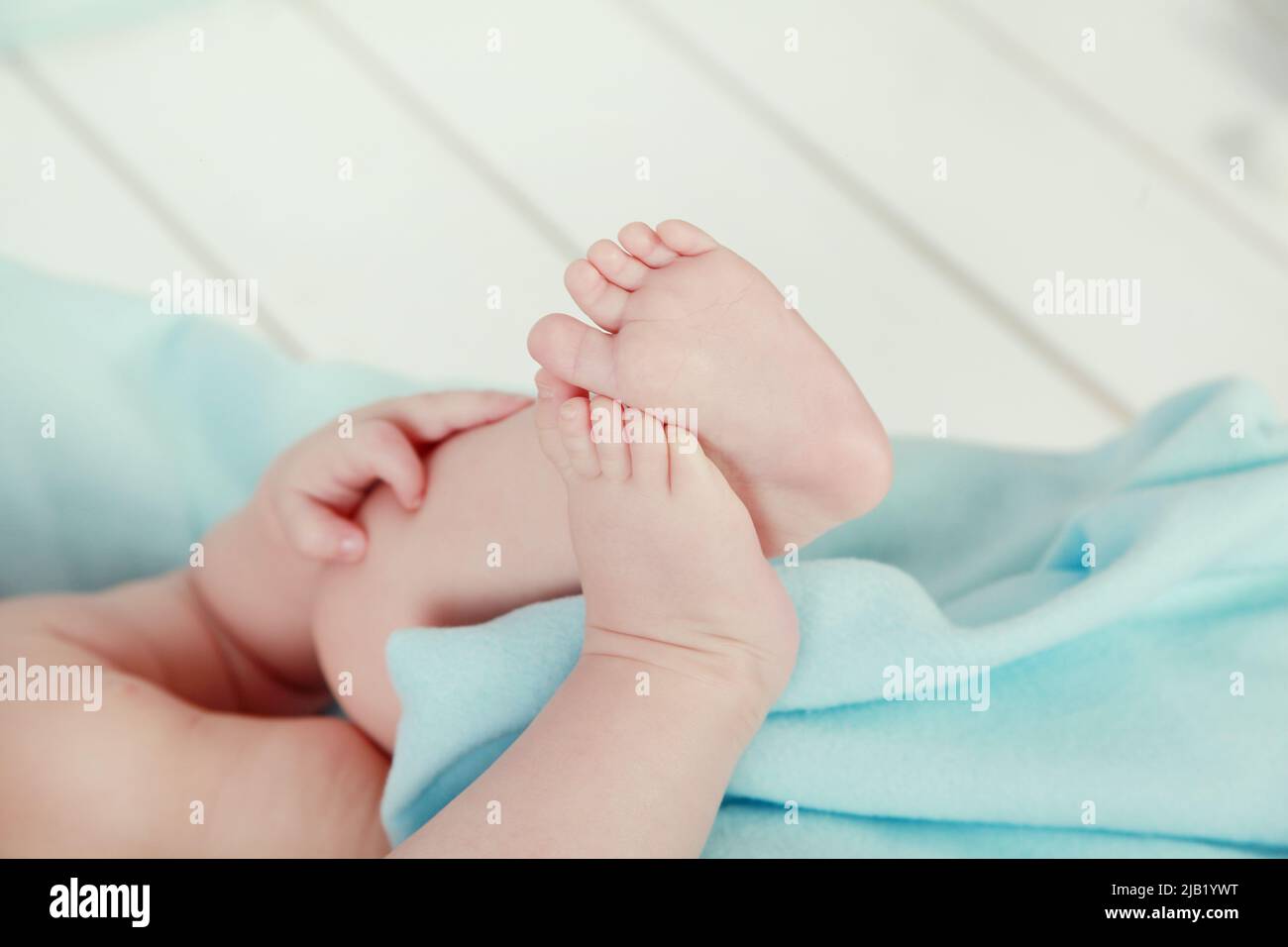 newborn child. baby legs. the legs of the newborn. legs on green