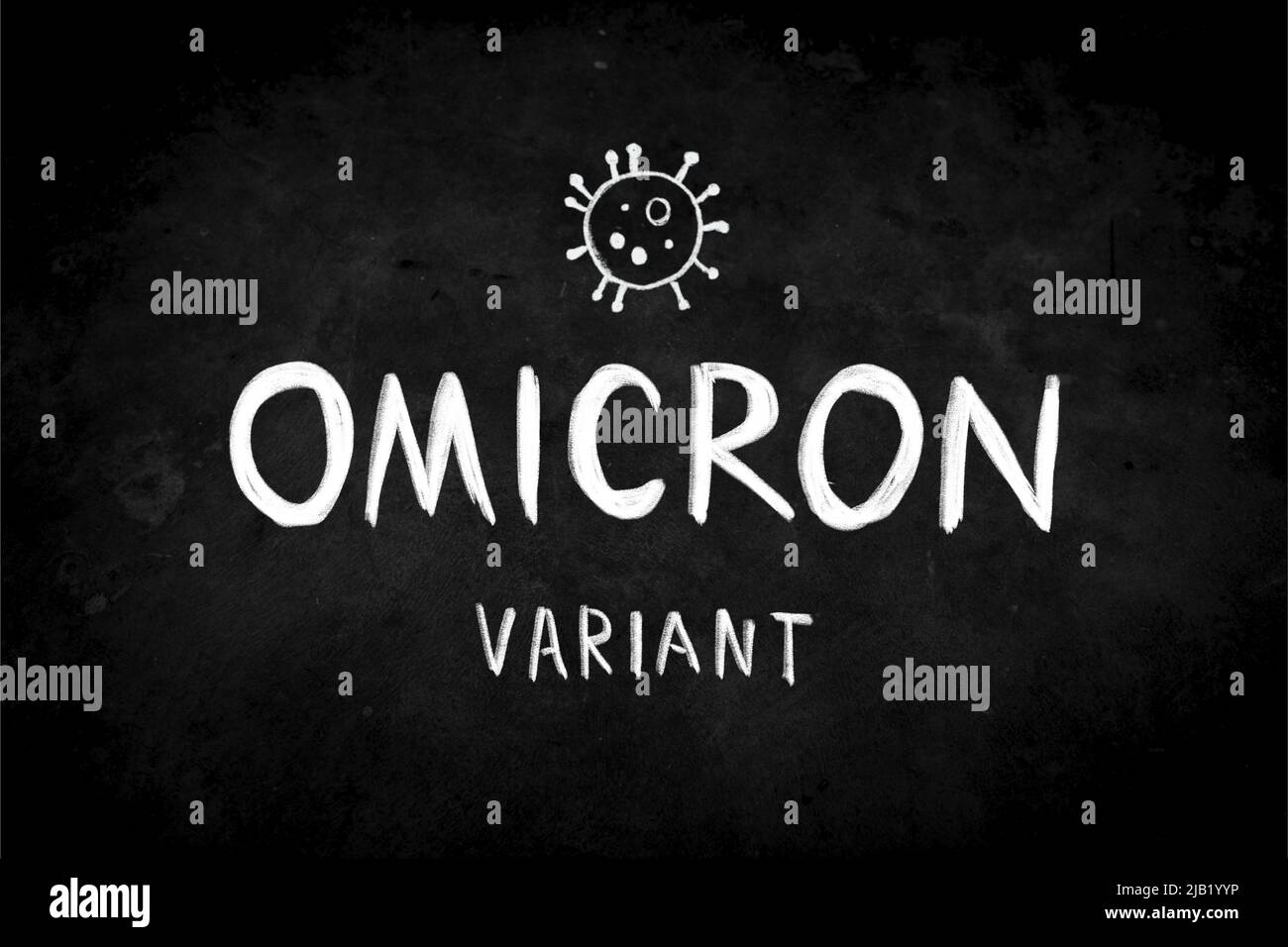 A phrase 'OMICRON Variant' by handwriting white coloured chalk on blackboard. New COVID-19 variants concept. The surface of blackboard is rough Stock Photo