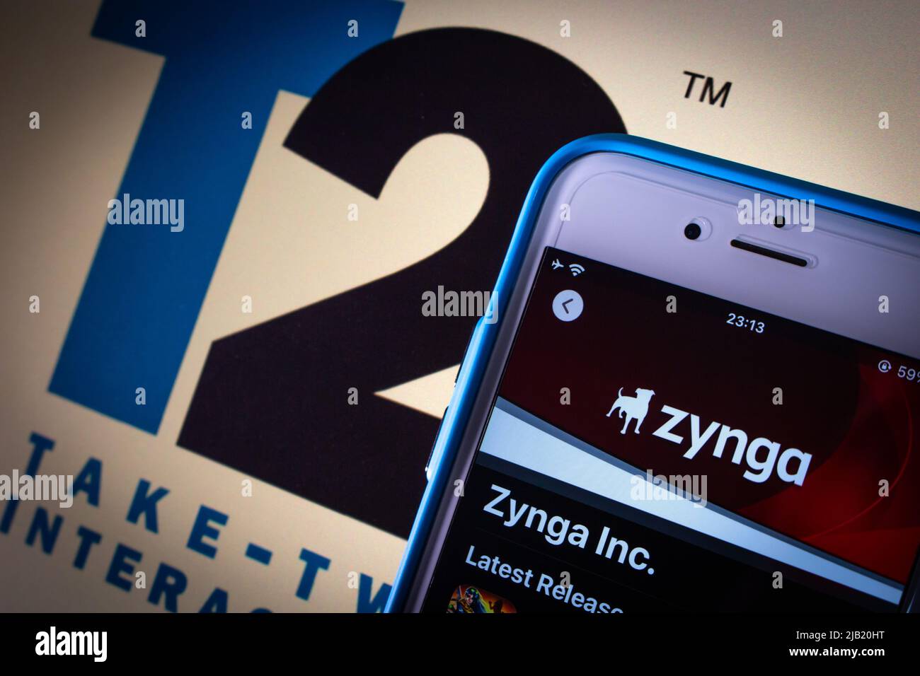 US social game developer Zynga Inc. on App Sore & Take-Two Interactive logo in dark mood. Take-Two announced its intent to acquire Zynga in Jan 2022 Stock Photo