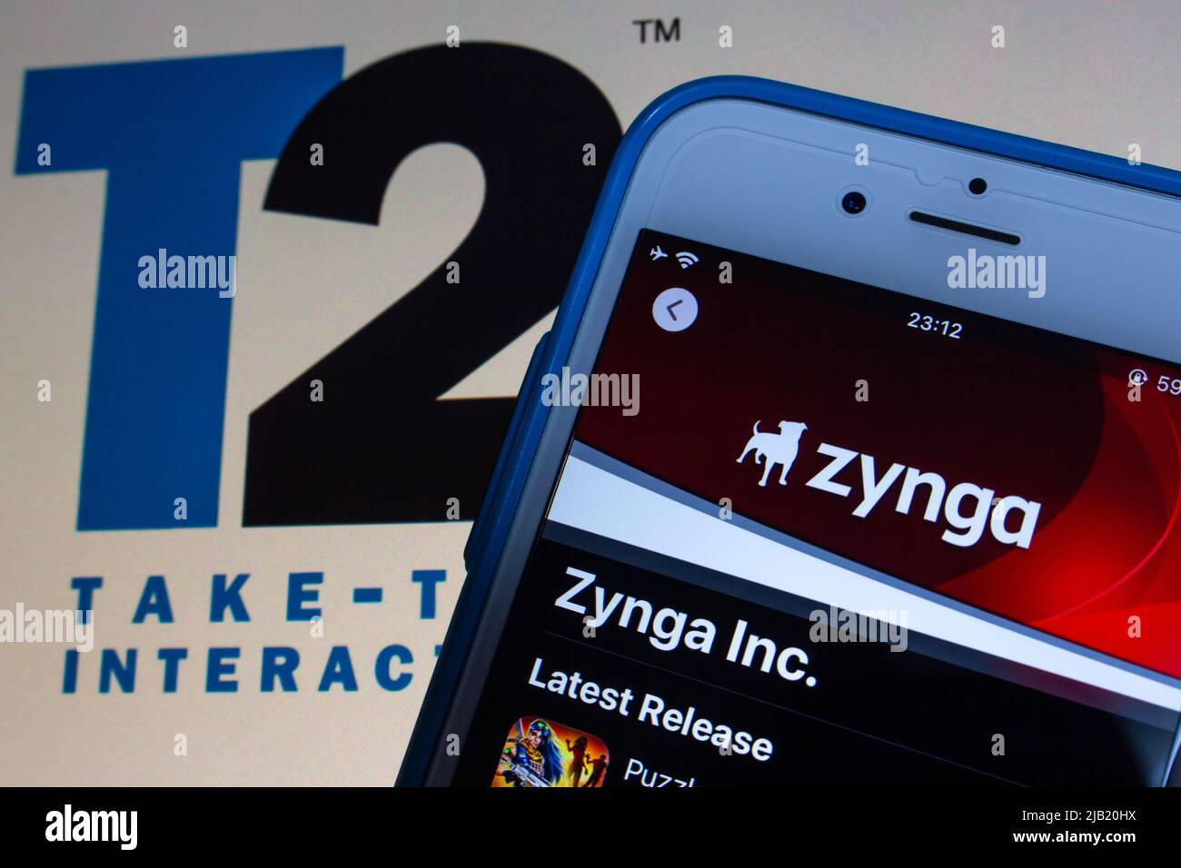 An US social game developer Zynga Inc. on App Sore on iPhone and Take-Two Interactive logo. Take-Two announced its intent to acquire Zynga in Jan 2022 Stock Photo