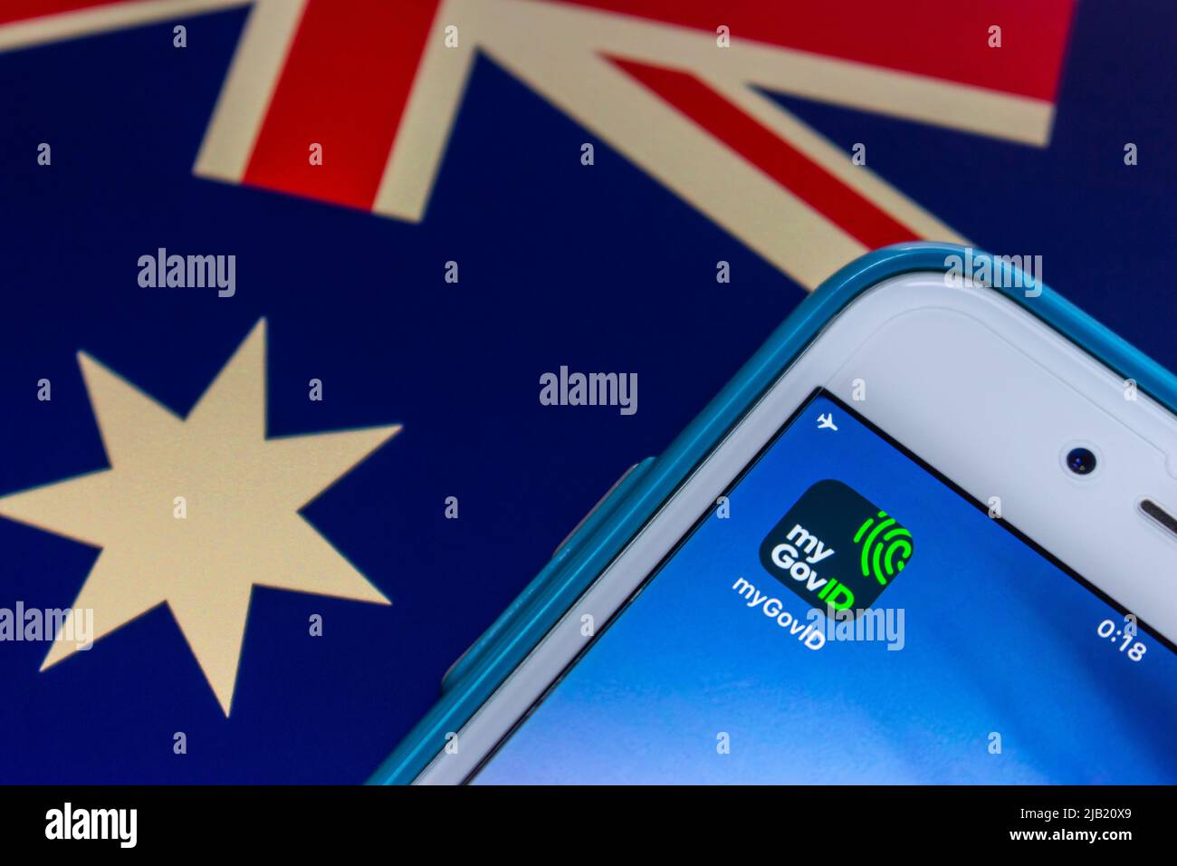 myGovID app, Australian Government's app that allows user to authenticate with Australian Government websites & services, on iPhone on Australian flag Stock Photo