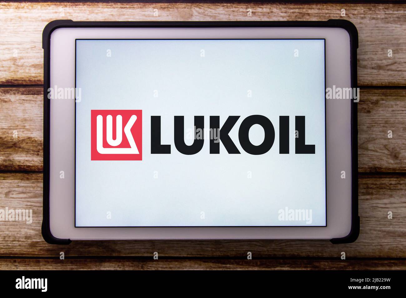 Logo of Lukoil on the tablet on the wooden table. The PJSC Lukoil Oil Company is a Russian multinational energy corporation headquartered in Moscow Stock Photo