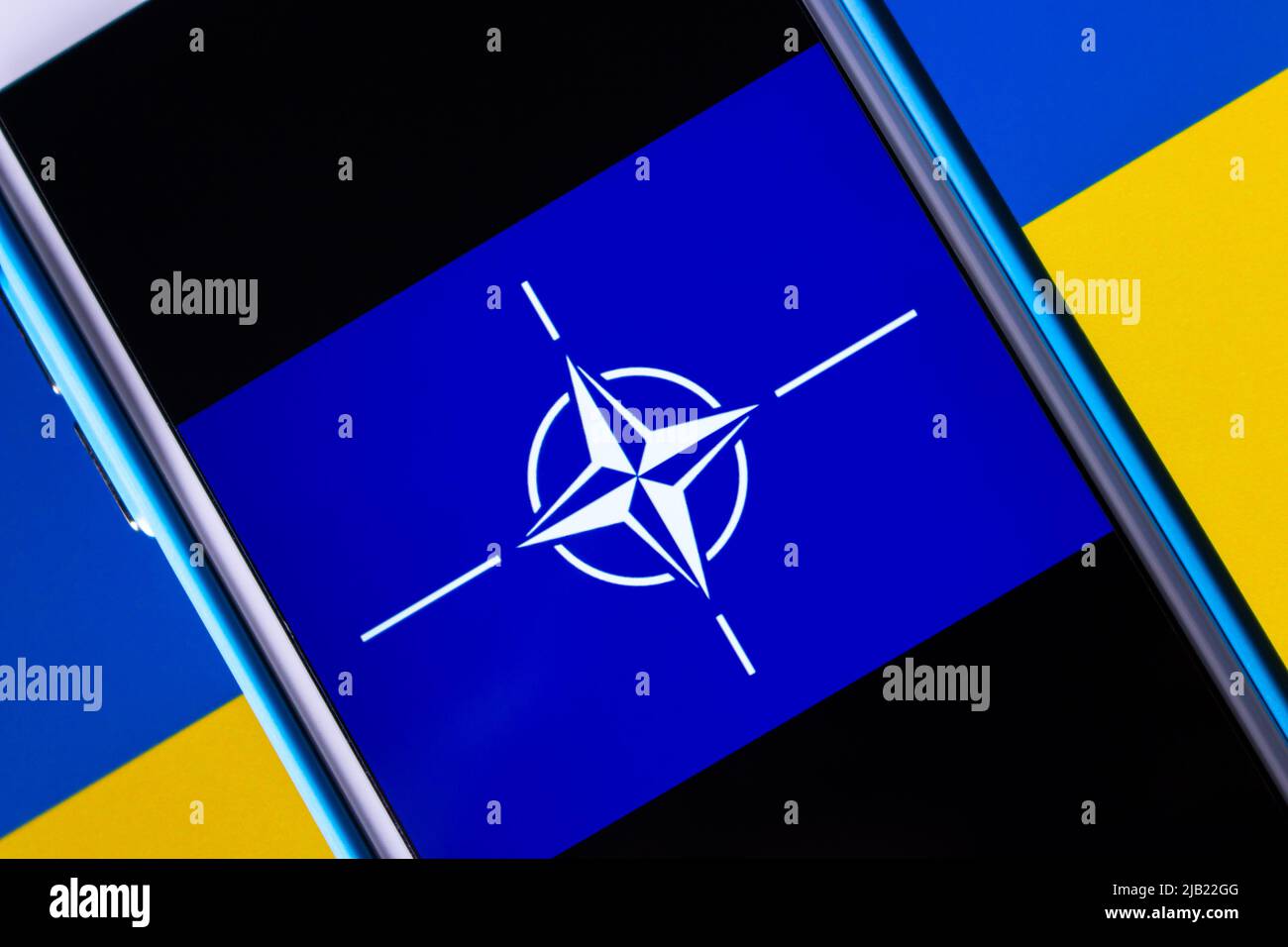 Logo of NATO (The North Atlantic Treaty Organization, OTAN) on Ukraine flag. NATO is a military alliance among 28 EU and 2 North American countries Stock Photo