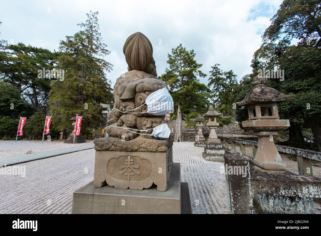 Komainu stone statue which wearing a facial mask at the Matsue Jinja