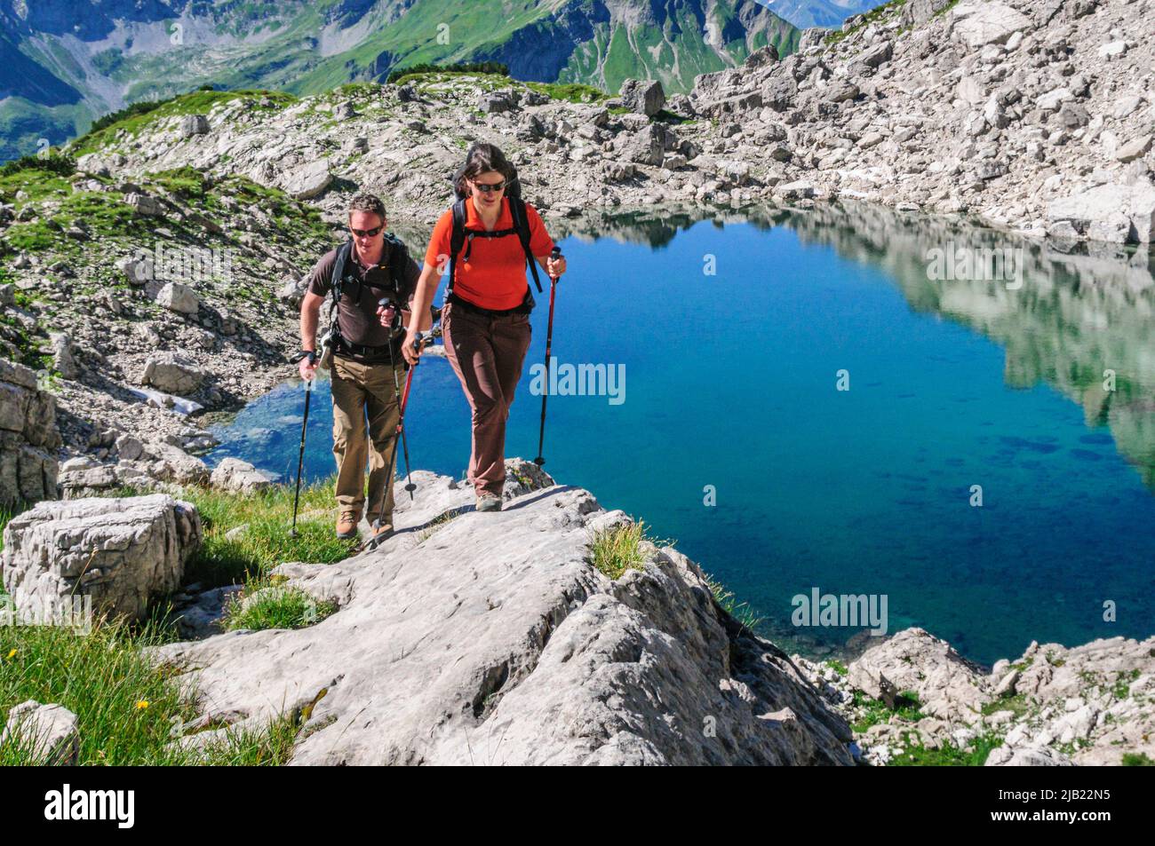 Hikers ascending to mountain top in Allgäu Alps near Oberstdorf Stock Photo