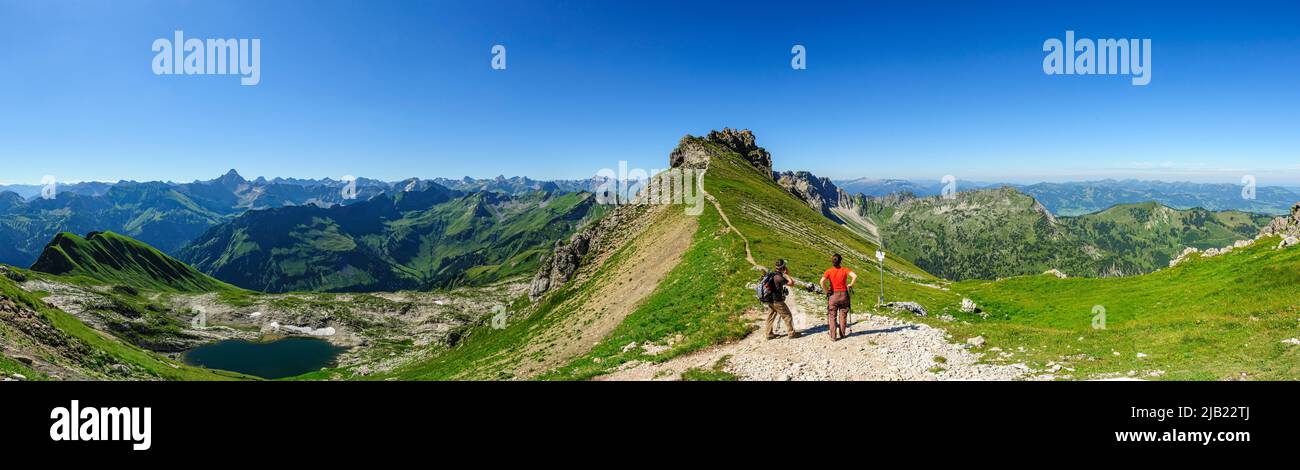 Hikers enjoying beautiful panorama of Allgaeu Alps Stock Photo