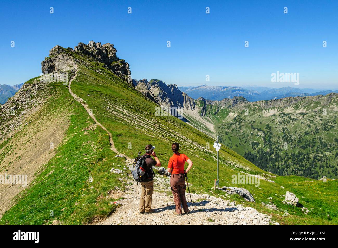Hikers enjoying beautiful panorama of Allgaeu Alps Stock Photo