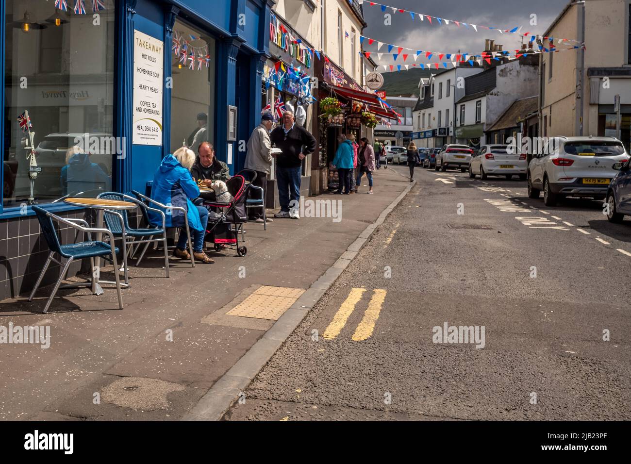 View of people in Largs North Ayrshire  town center with May sunshine Stock Photo