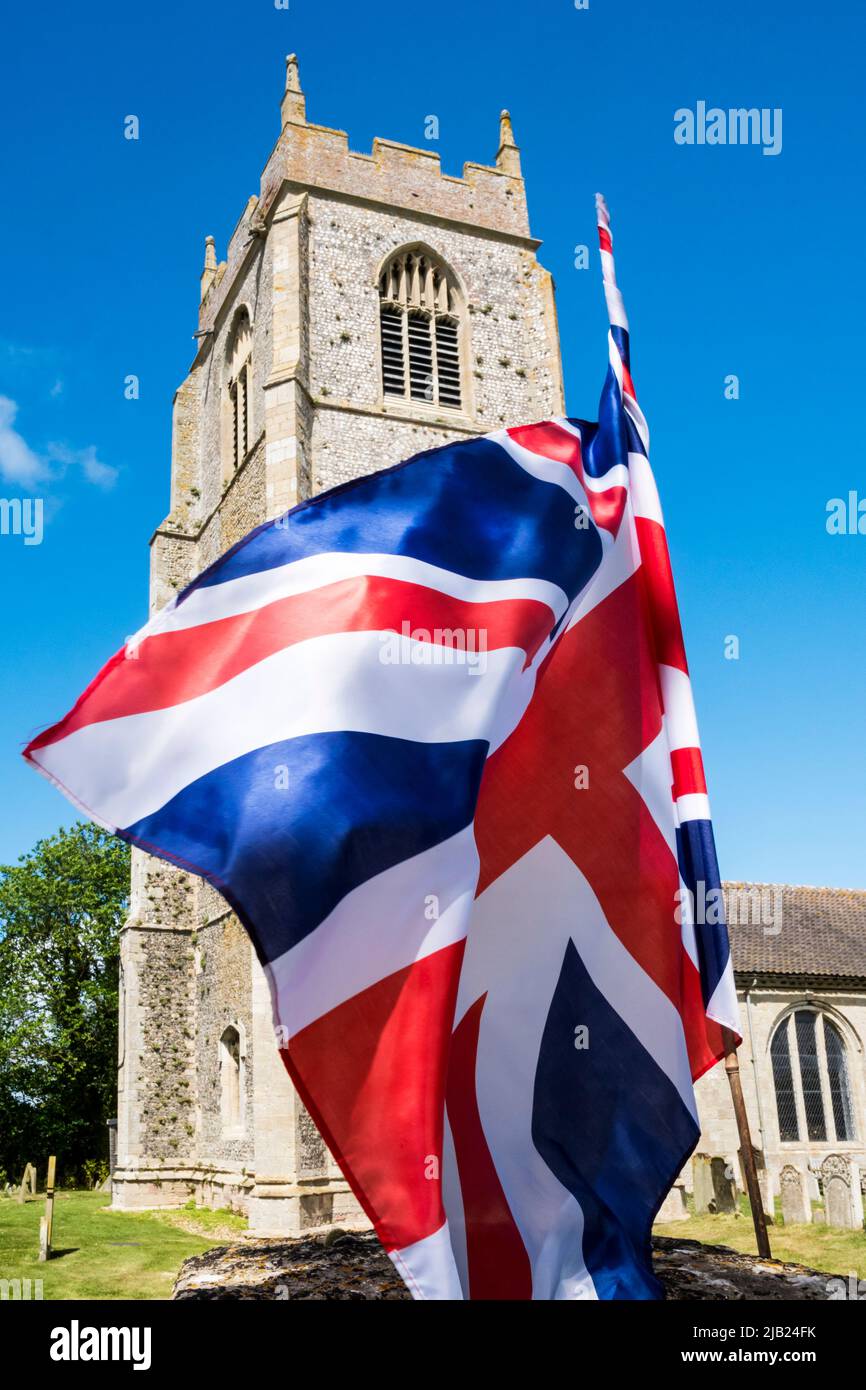 A large union jack for the 2022 Queen's platinum jubilee in front of St Mary's church at Holme-next-the-Sea, north Norfolk. Stock Photo