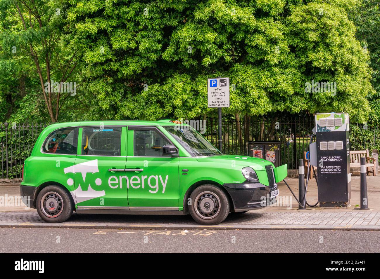 Ovo Energy branded E-taxi recharging at a dedicated rapid electric charging point in central London. Stock Photo