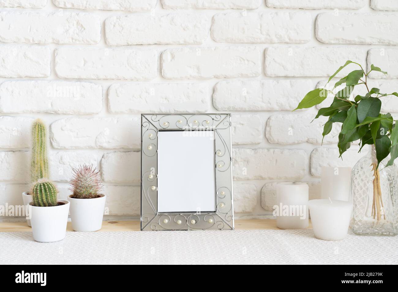 Square wooden photo frame and cactus plants on the table Stock Photo ...