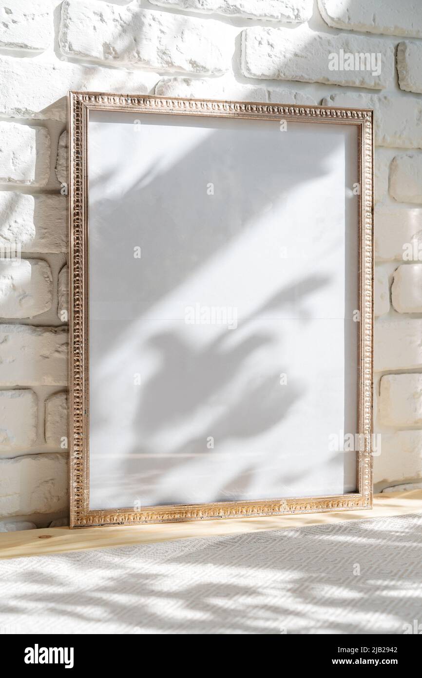 Photo frames on floor over white brick wall Stock Photo