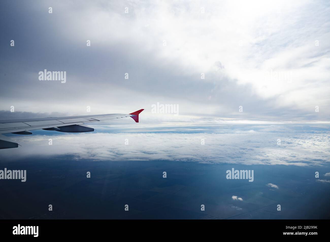 Aircraft wing above beautiful clouds and blue sky Stock Photo - Alamy
