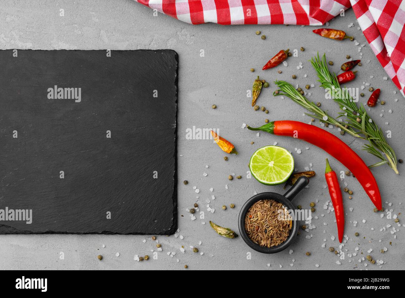 Various spices and herbs on gray background Stock Photo